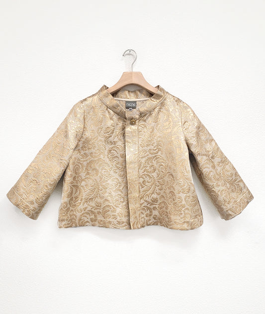 gold brocade jacket with single button on a hanger with a white background