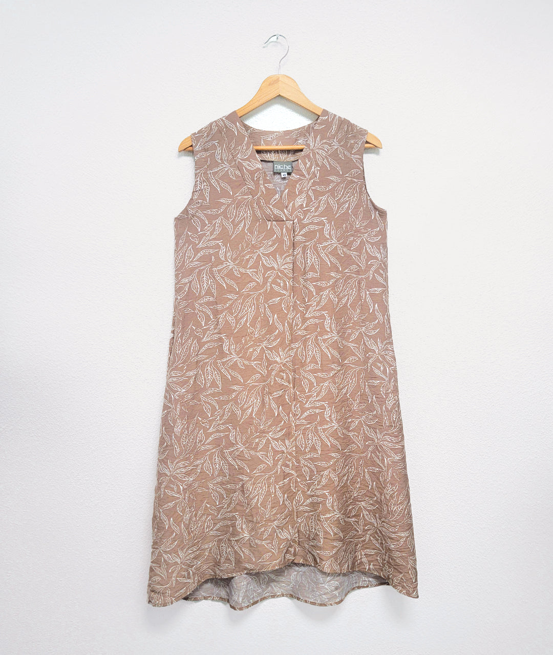 taupe sleeveless dress with a vneck and a white leaf print