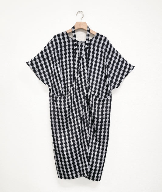 black and white diamond stripe tunic with a strap from the hips worn around the neck