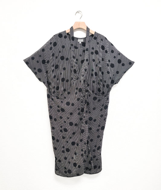 black and white stripe tunic with a black dot print circle design. dress has a strap from the hips worn around the neck