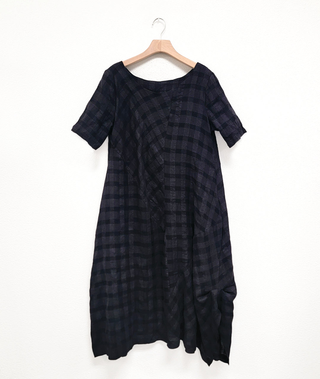 large check print dress with an asymmetrical body, round neckline, elbow length sleeves, and contrasting panels across the body