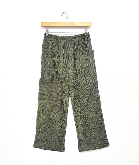 wide leg black and green striped pant with asymmetrical cargo pockets and an elastic waistband