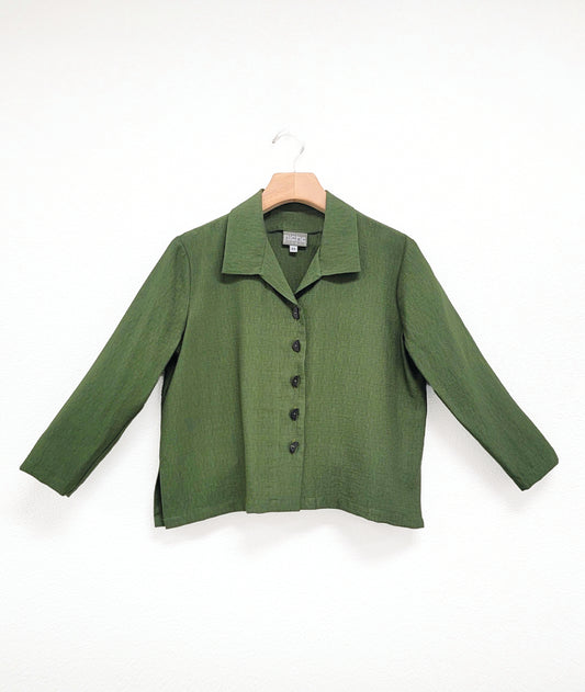 pine green button down blouse with a short boxy body and 3/4 sleeves. small splits at either hip seam