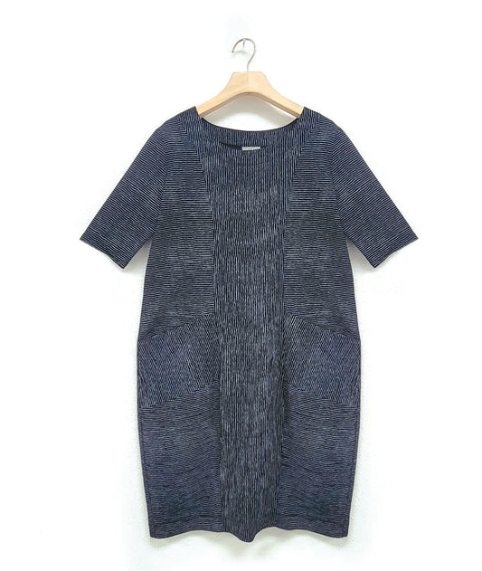 grey and black striped shift dress with princess seams and alternating panels of contrasted stripe direction. dress has short sleeves, a round neckline, and is about knee length