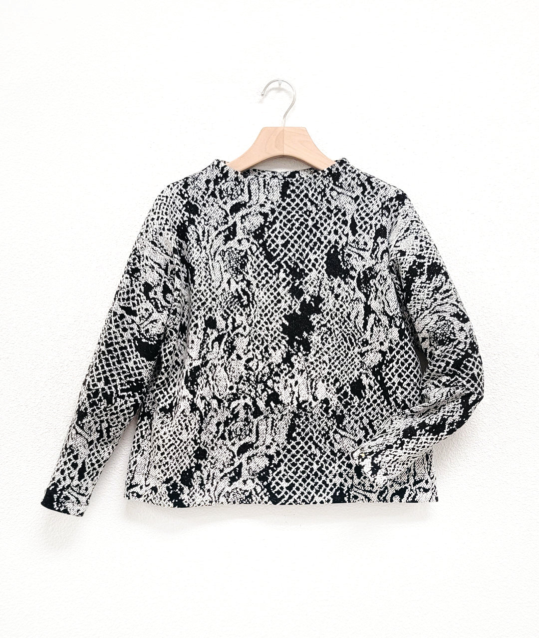 black and white lace print knit pullover top with a high neckline and dolman sleeves. 