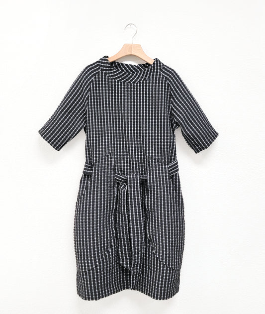 black and white mini plaid raglan sleeve shift dress with a matching tie belt at the waist, which runs through exterior pocket loops