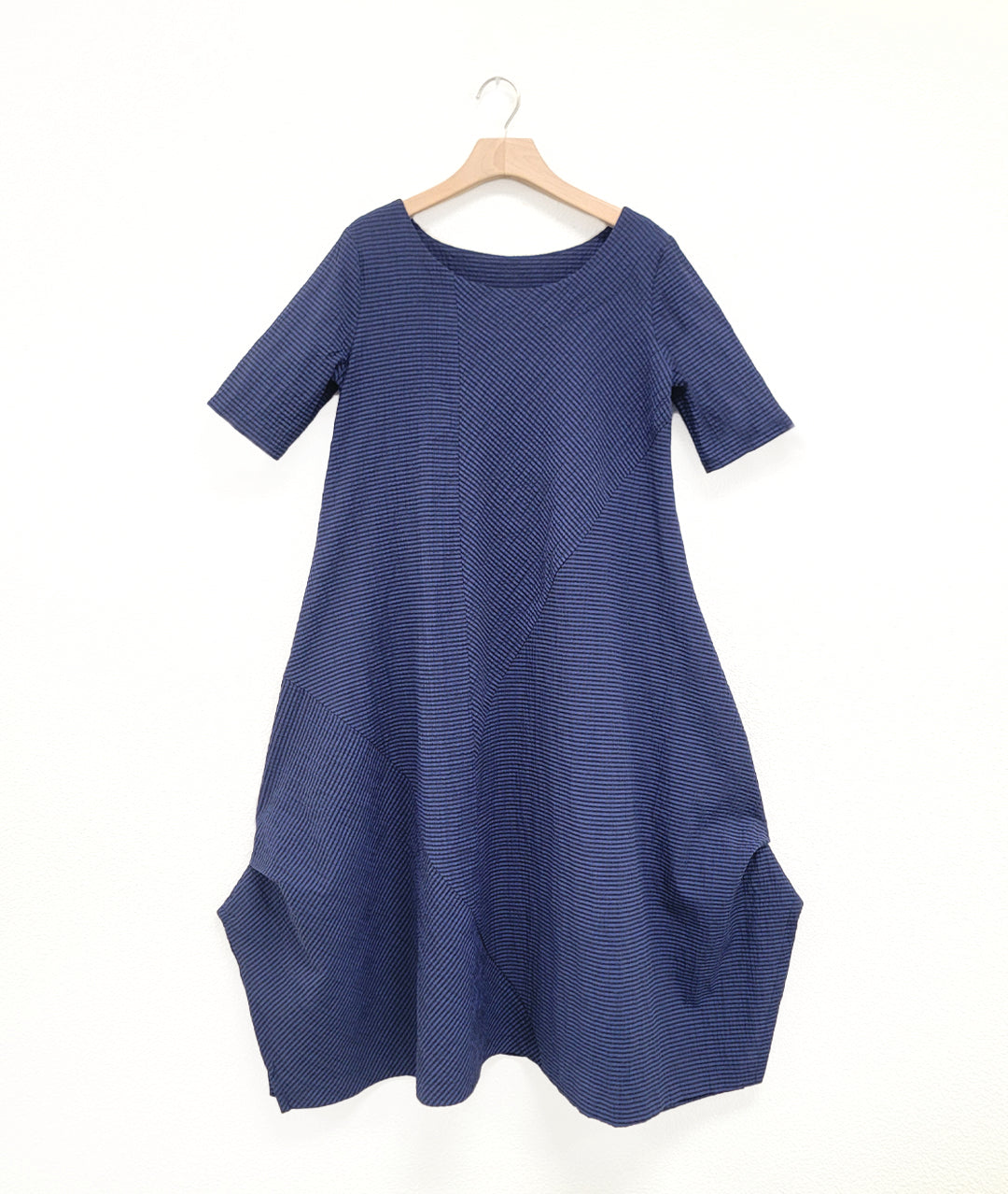 black and blue striped dress with contrasting panels and tucks on the sides