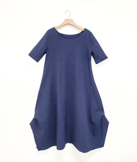 black and blue striped dress with contrasting panels and tucks on the sides