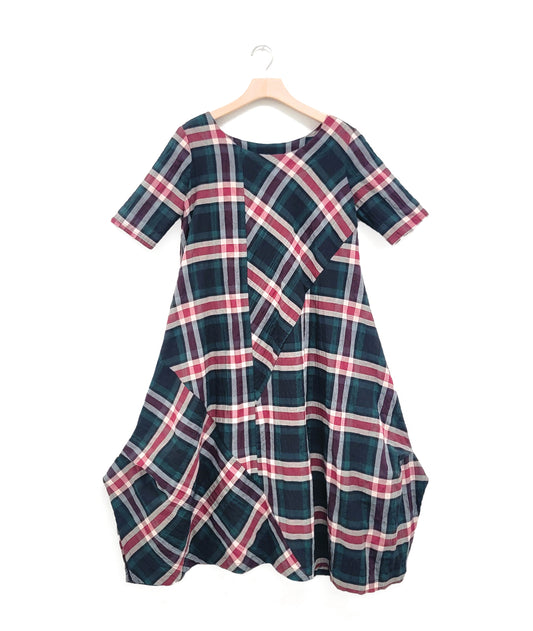 red and green plaid dress with contrasting panels and tucks on the sides