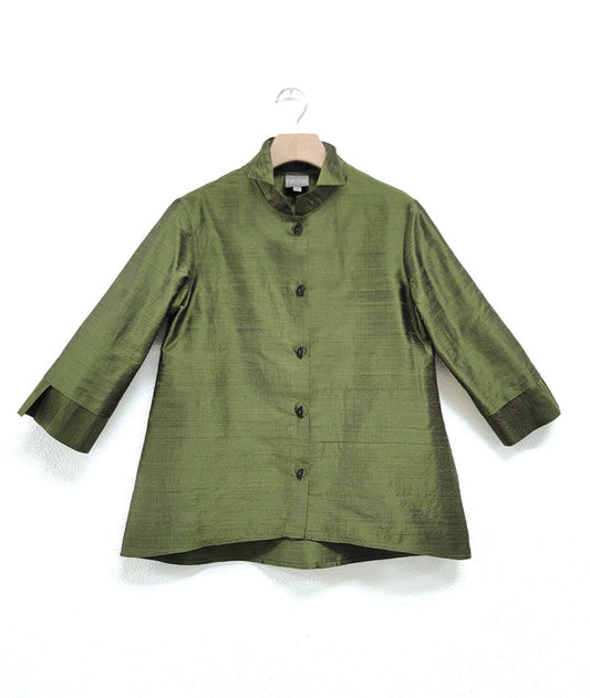 green dupioni silk blouse with black half-moon buttons, a wide cuff on a 3/4 sleeve, and a double collar. blouse has a lower hem in the back.