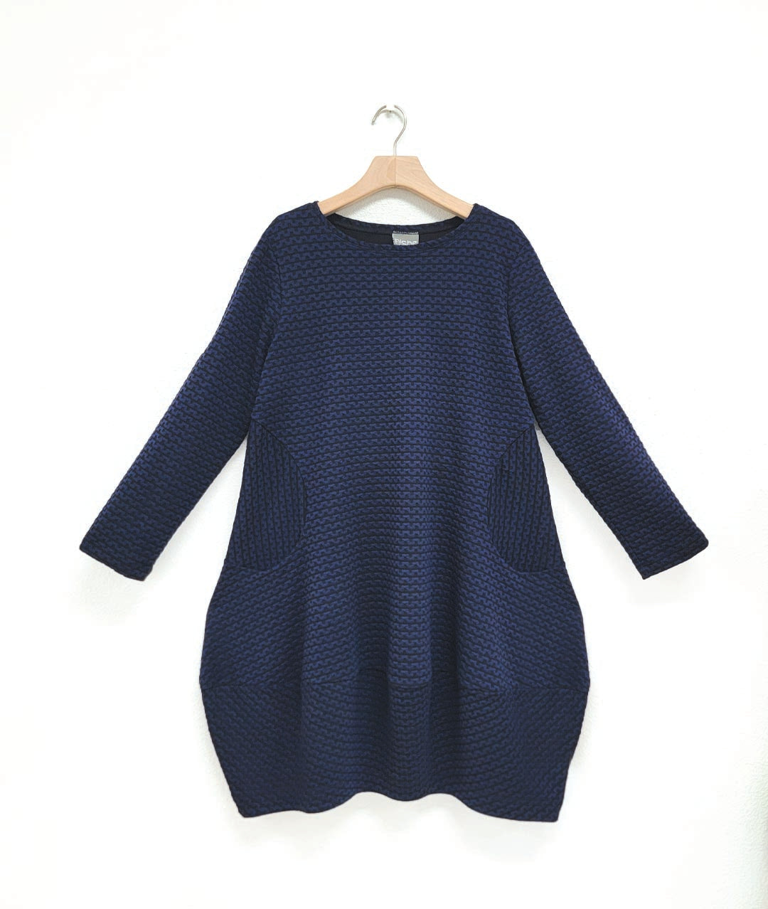 black and blue zipper print pullover dress with long sleeves and a tulip shaped silhouette 