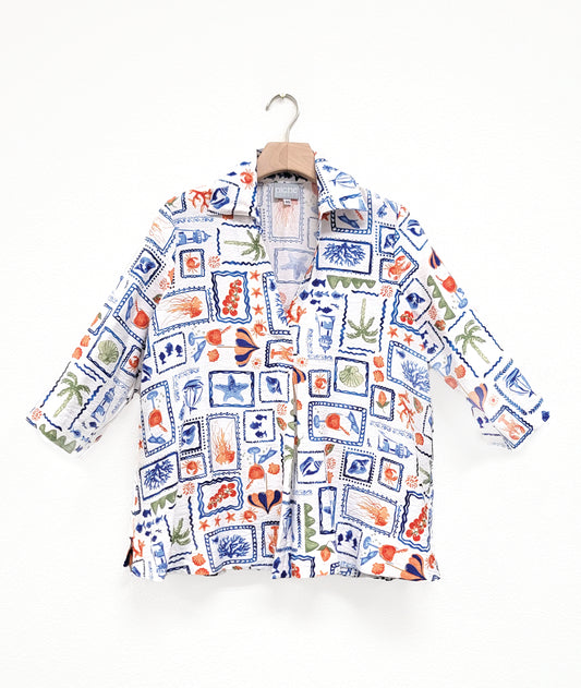 white beach print pullover blouse with 3/4 sleeves, side splits, a v-neck and open collar