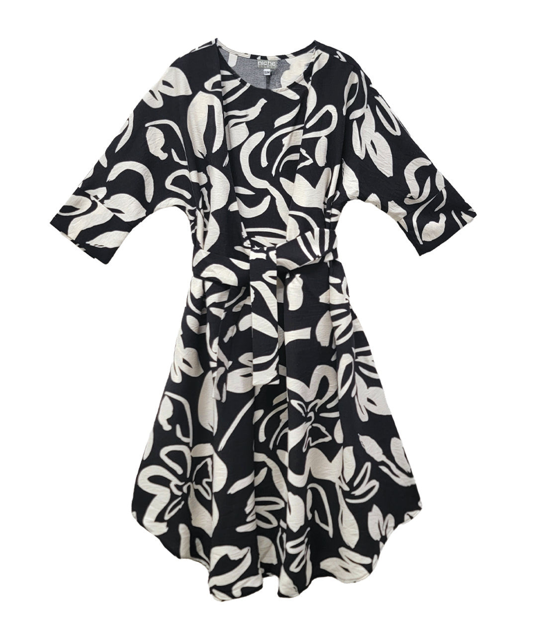 black floral patterened dress with ties at the waist, on a white background