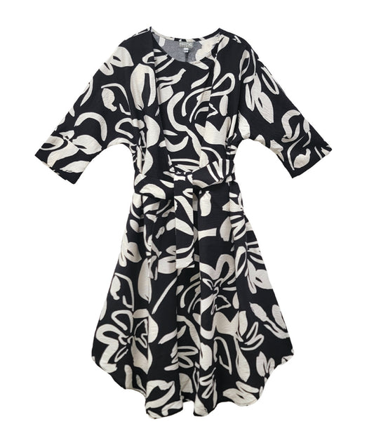 black floral patterened dress with ties at the waist, on a white background