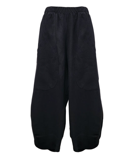 wide leg black pant with a tapered ankle, oversized exterior pockets, and a tiny grid texture