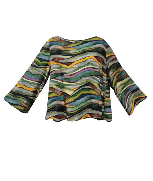 A women's long-sleeve top with a wavy, multicolored abstract pattern featuring stripes of green, yellow, purple, orange, and black on a white base, displayed against a solid white background.