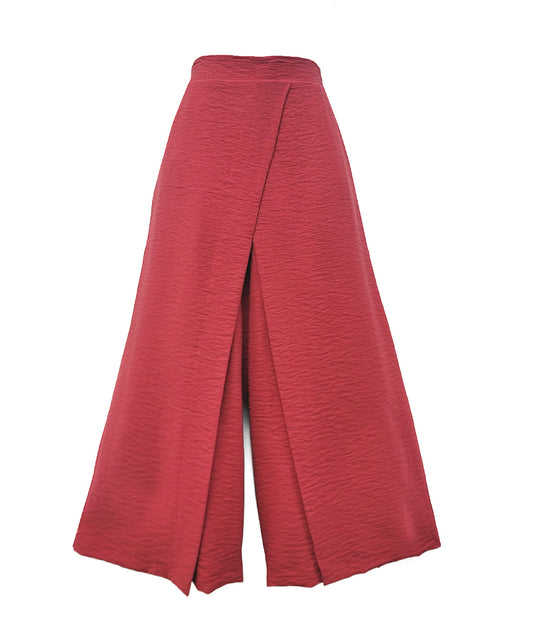 a muted red wide leg pant with an overlapping panel in the front from each leg