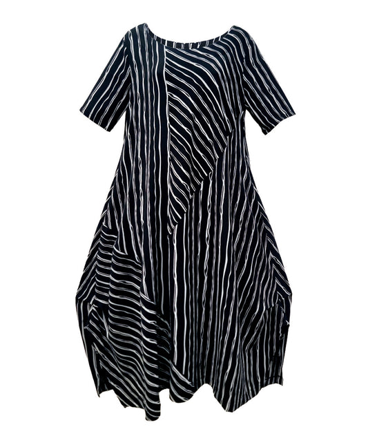black and white striped dress with contrasting panels of directional stripes. Dress has a round neckline, elbow length sleeves and splits and tucks at the sides