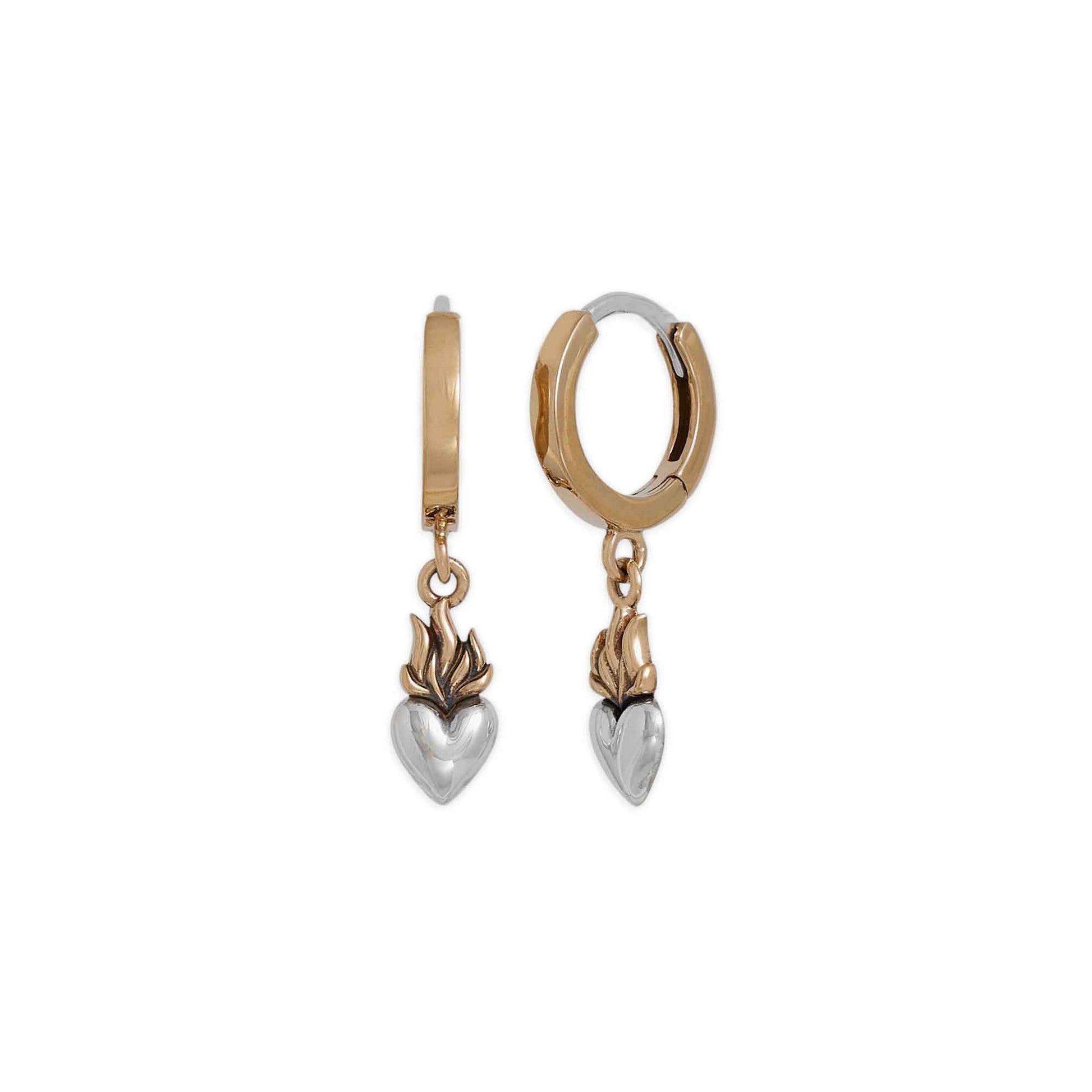 Gold and silver hoop earrings with heart-shaped charms on a white background