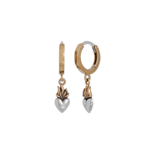 Gold and silver hoop earrings with heart-shaped charms on a white background