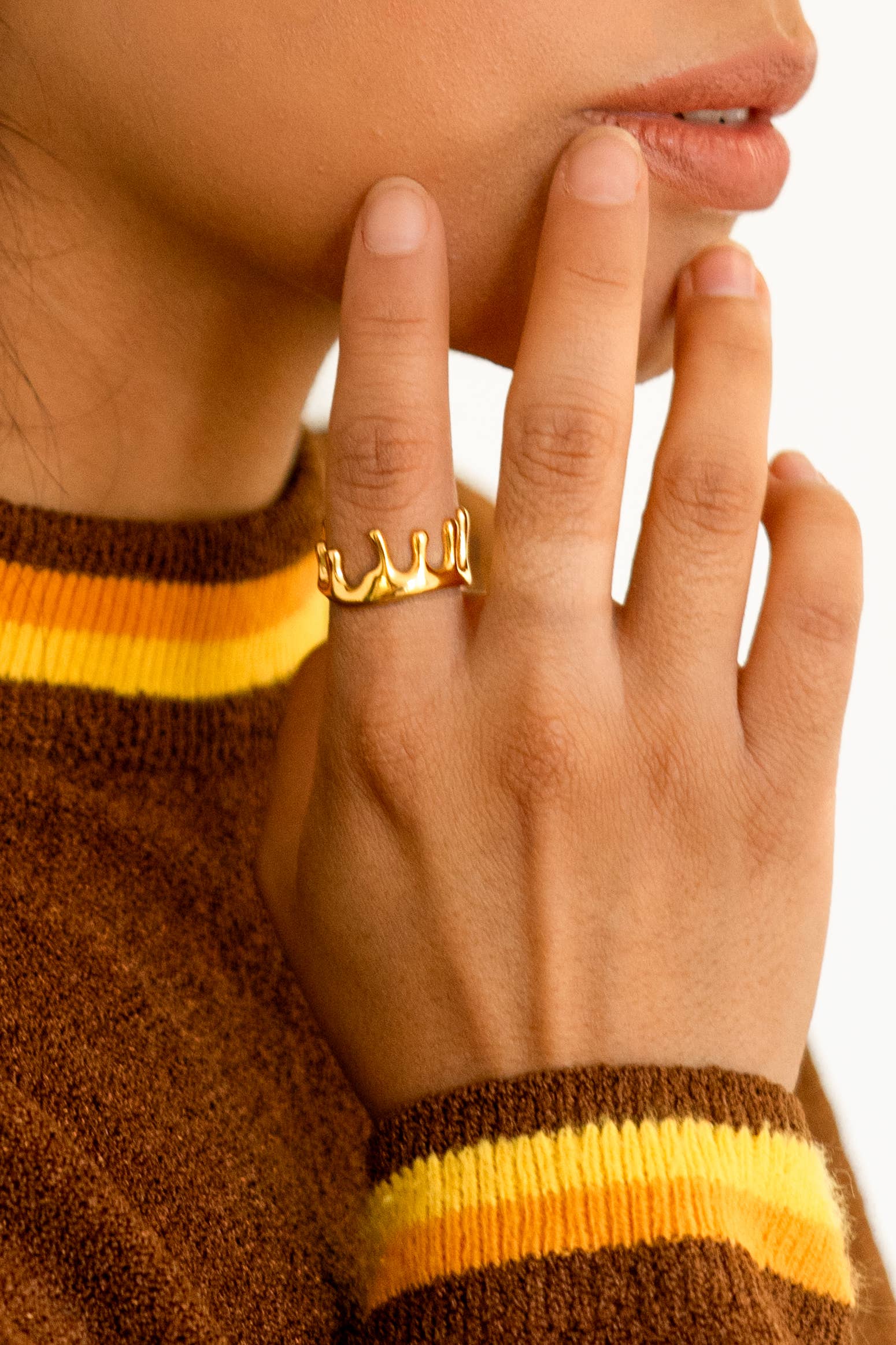 model is wearing a dripping gold ring