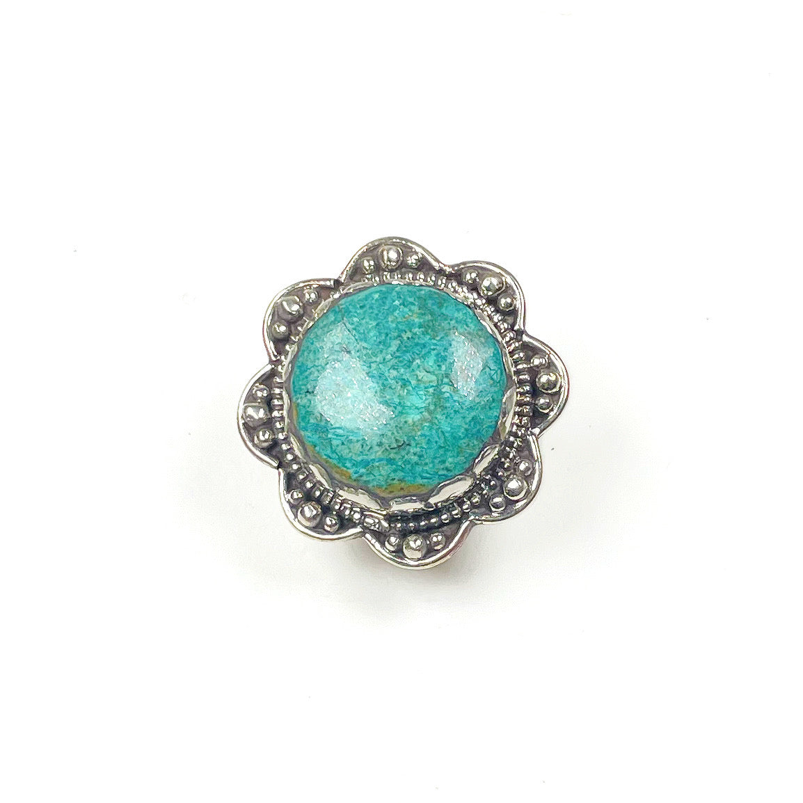 Teal colored chrysocolla stone  ring with silver metal scalloped edge.