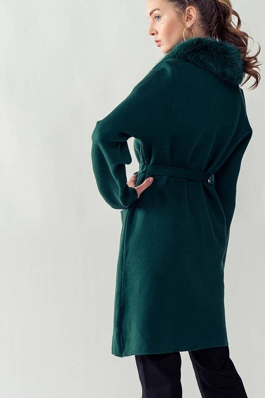 model showing back of  hunter green cover up featuring tie belt and fur collar