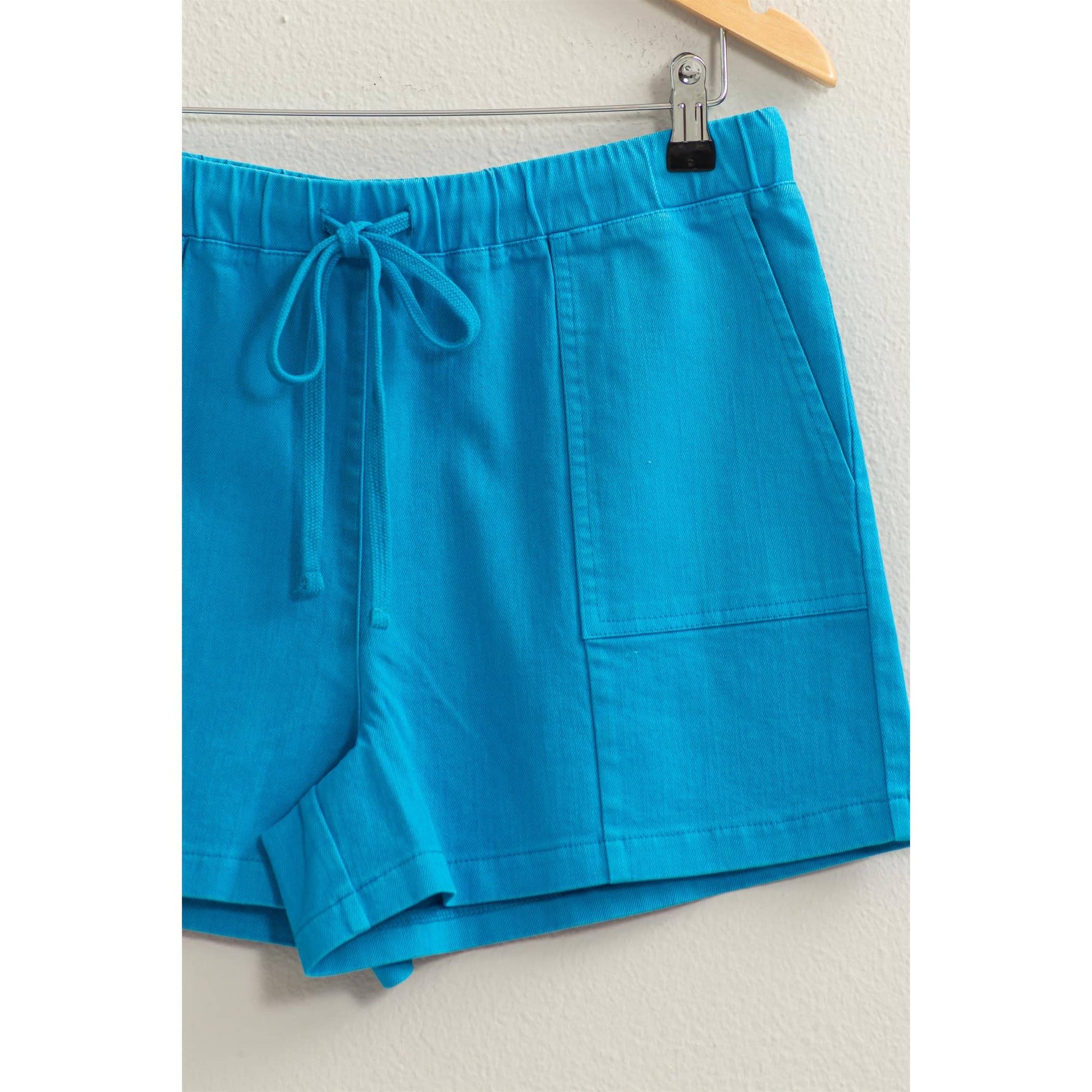 blue drawstring shorts on hanger