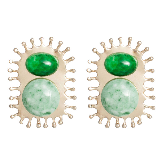 A pair of gold-toned statement earrings featuring two oval green cabochon stones in a sunburst-like setting, shown on a plain white background.