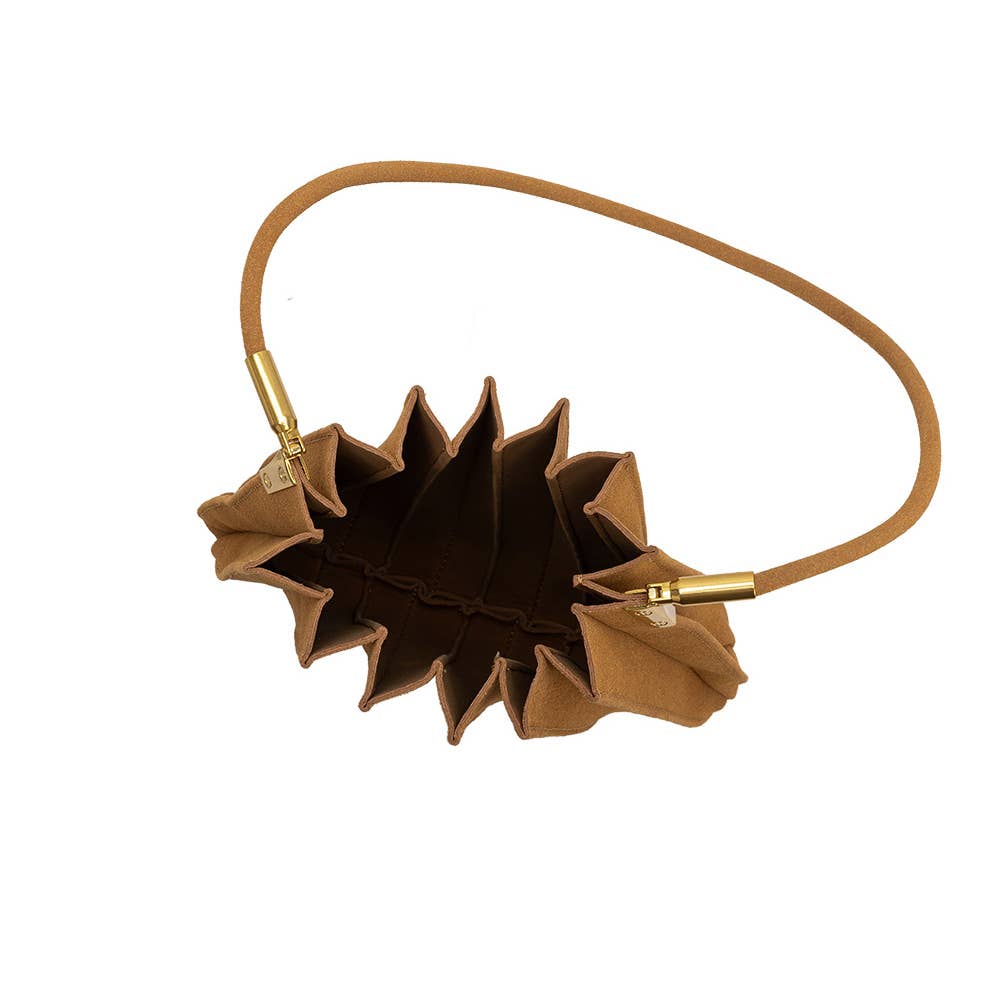 A brown suede shoulder bag with a unique pleated, accordion-like exterior and a thin matching strap, shown on a plain white background.