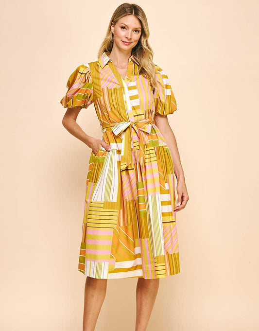 model wearing yellow pattern midi dress with tie across waist, puff short sleeves, pockets and collar