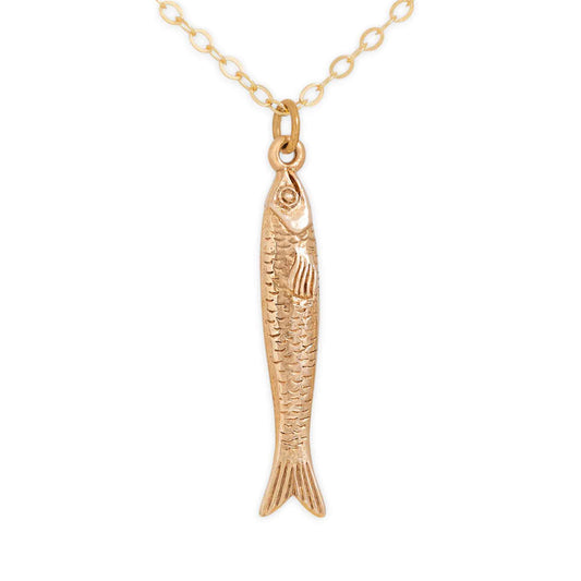 Gold fish-shaped pendant on a chain against a white background