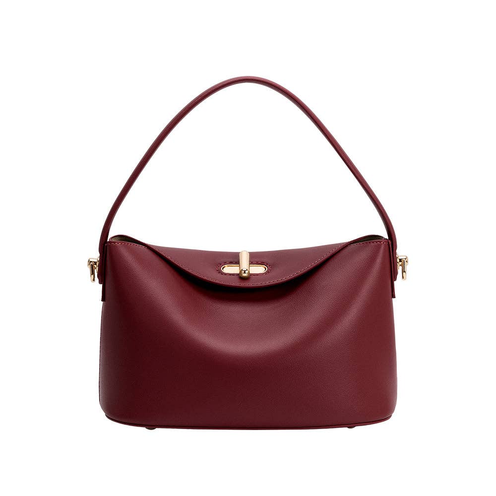 A burgundy leather shoulder bag with a curved top handle and a gold-tone cross-shaped clasp on the front flap, shown against a plain white background.