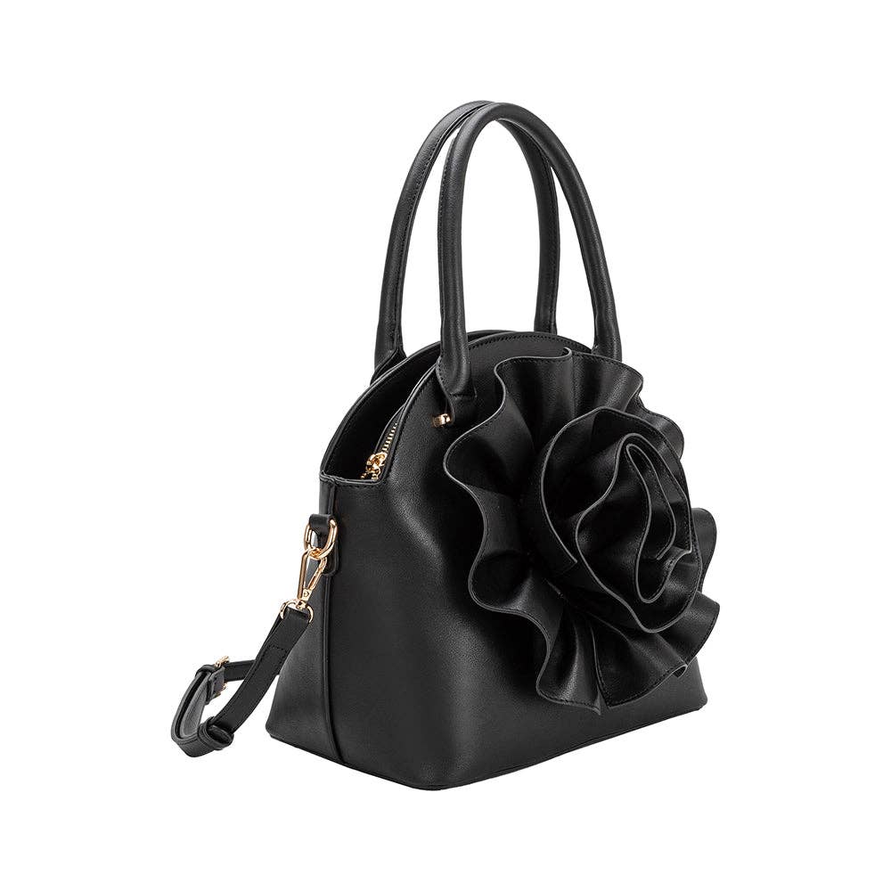 side view of black handbag with large flower detailing and crossbody strap on white background