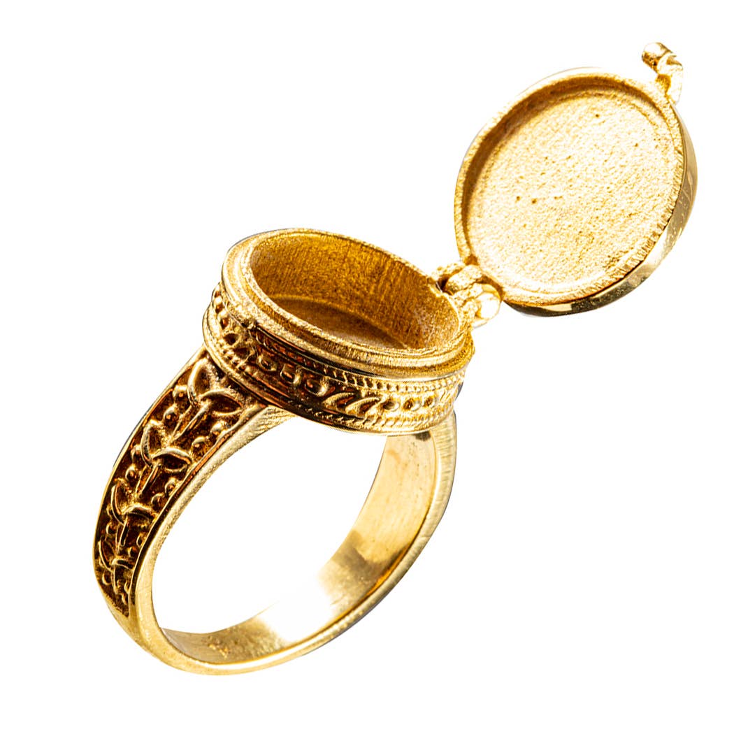 brass “poison” ring with detailed designs opened up to show it can store small things inside