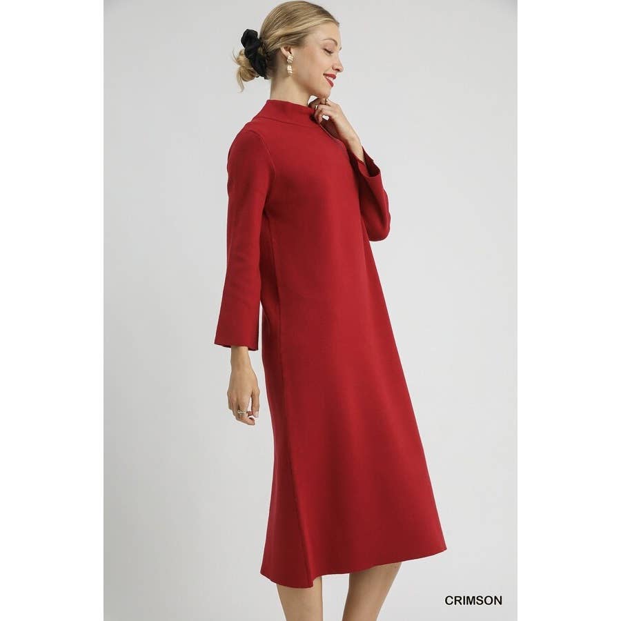 Woman wearing a red midi mock neck knit dress on a white background