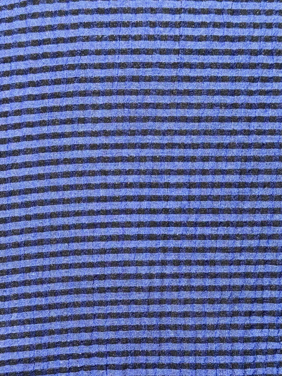 close up of blue and black striped fabric 