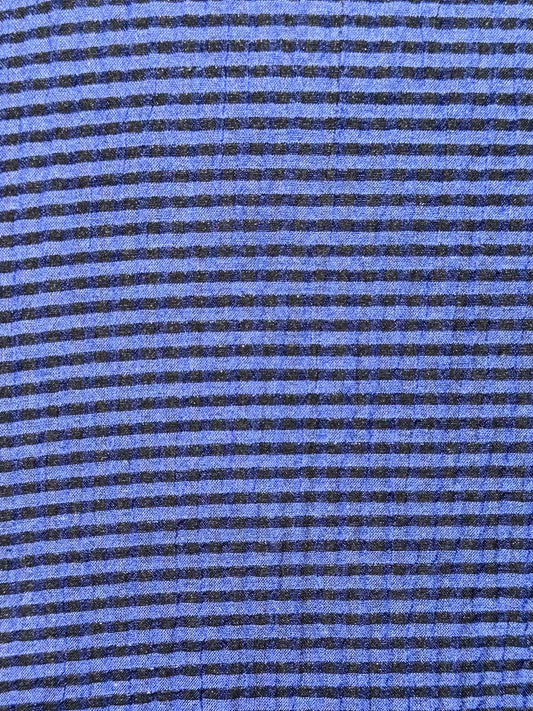 close up of blue and black striped fabric 