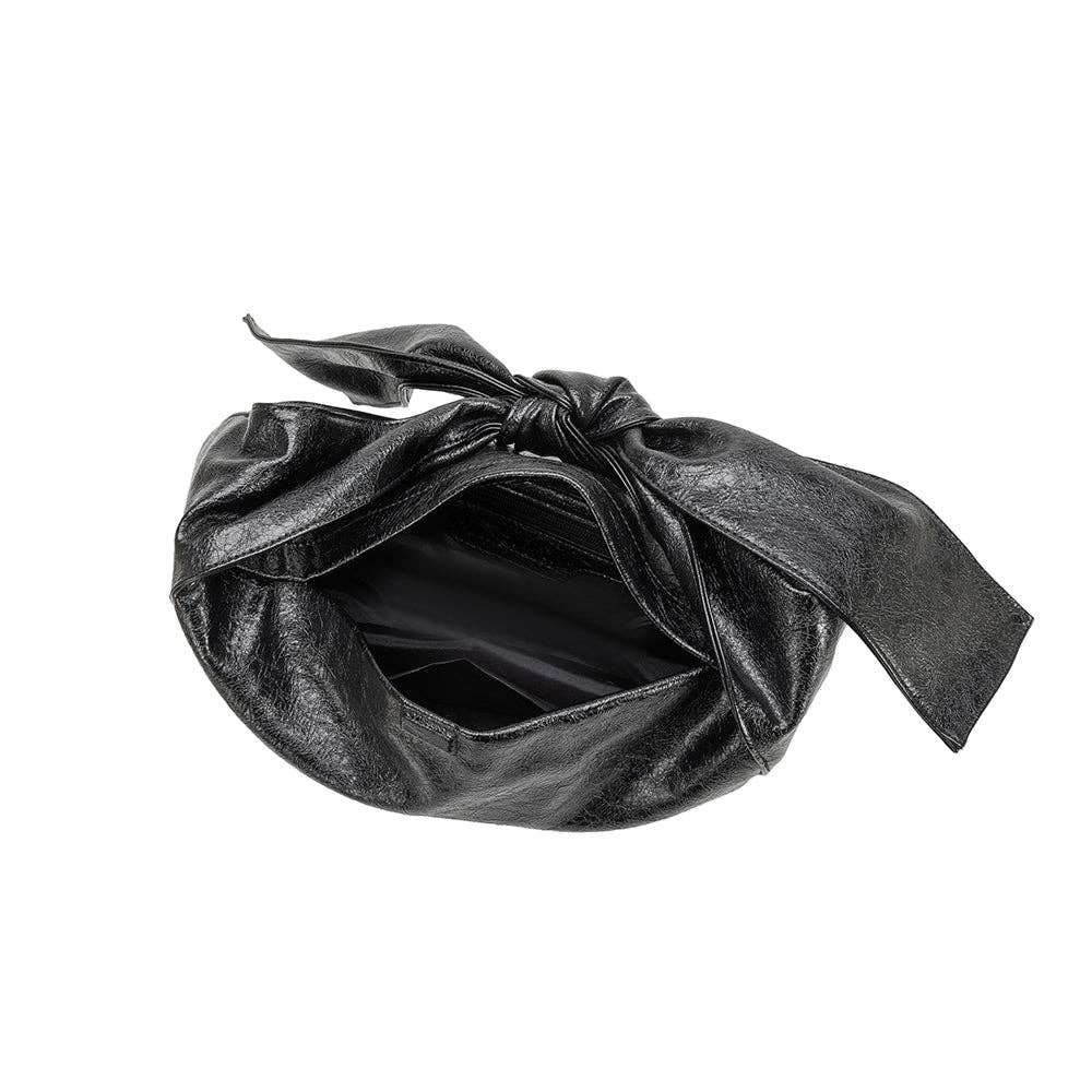 inside view of black handbag with bow strap on a  white background