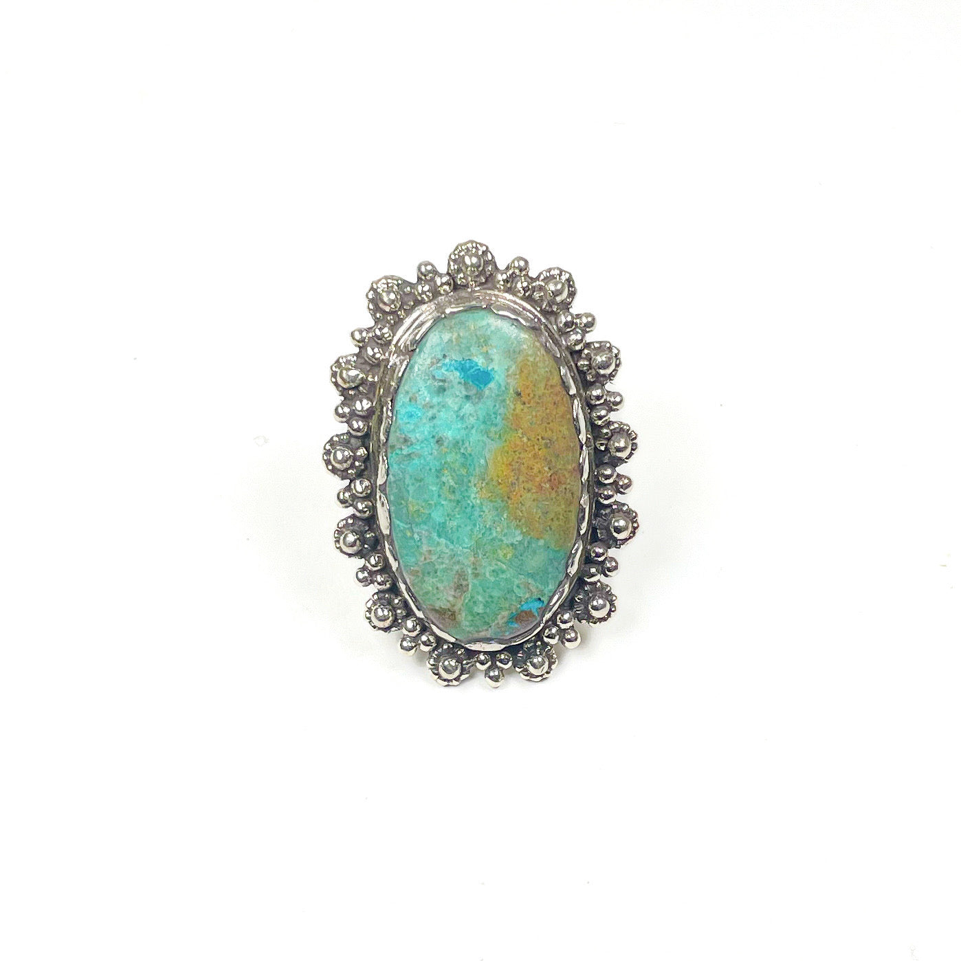Teal and tan chrysocolla oval stone ring with a silver metal intricate floral border