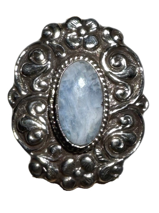 Silver ring with an oval stone on a white background