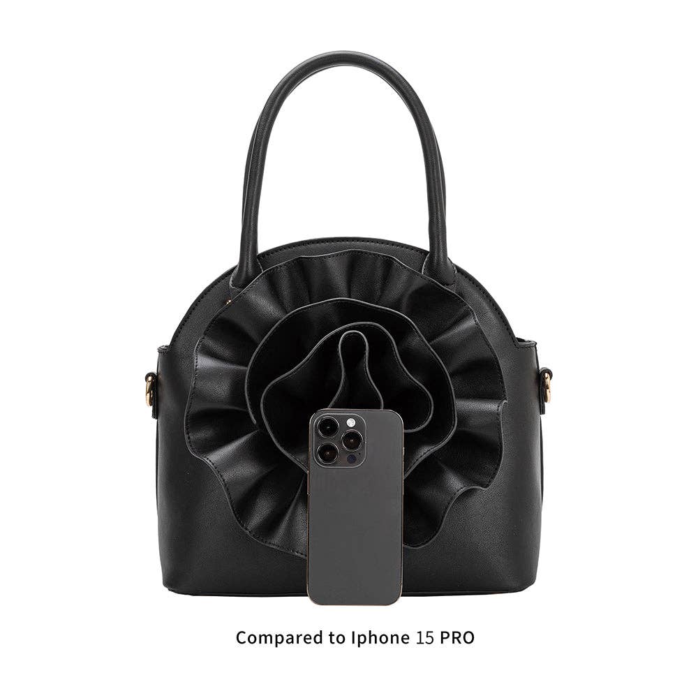 picture comparing iphone 15 pro size to black handbag with large flower detailing  on white background