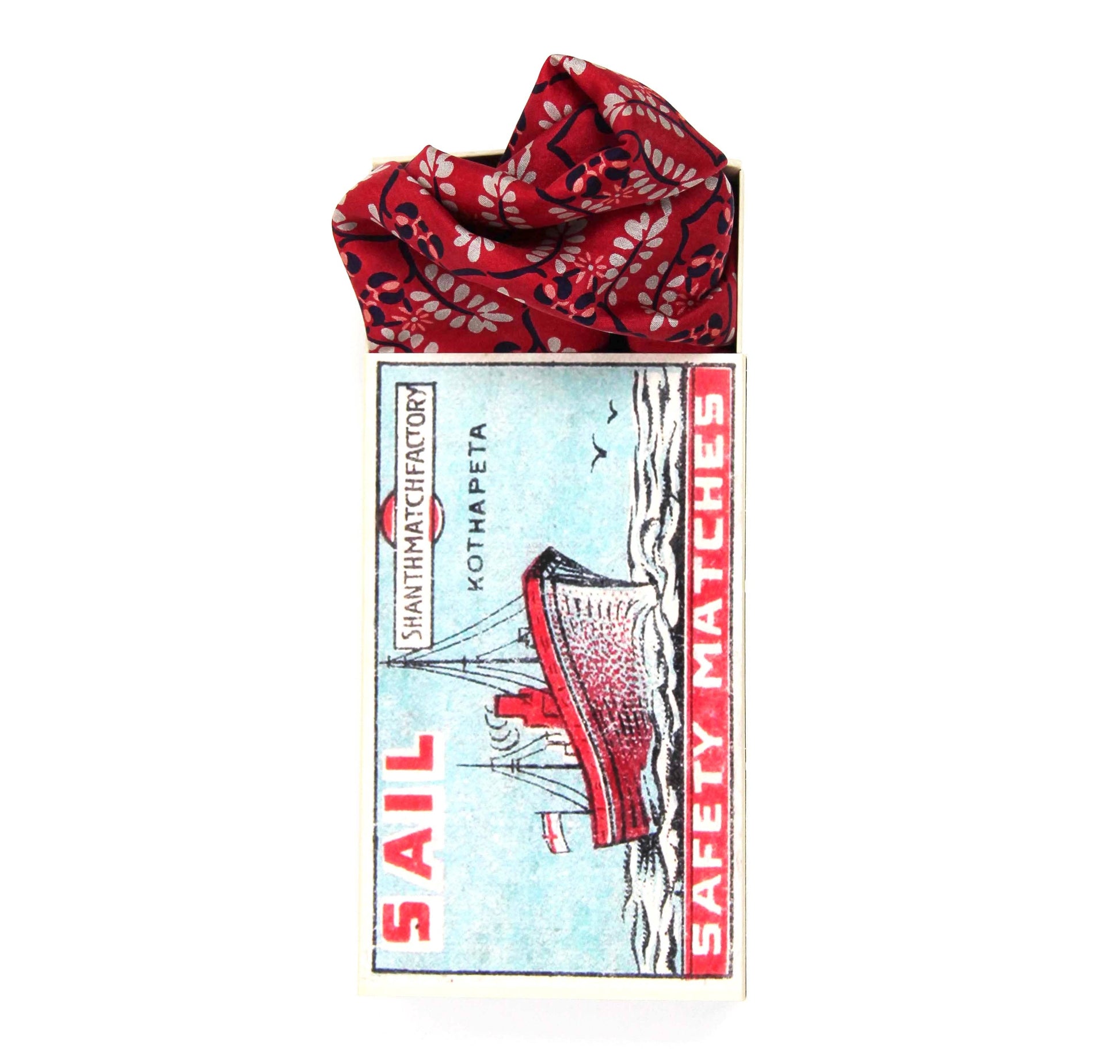 Matchbox with a red and black patterned cover on a white background
