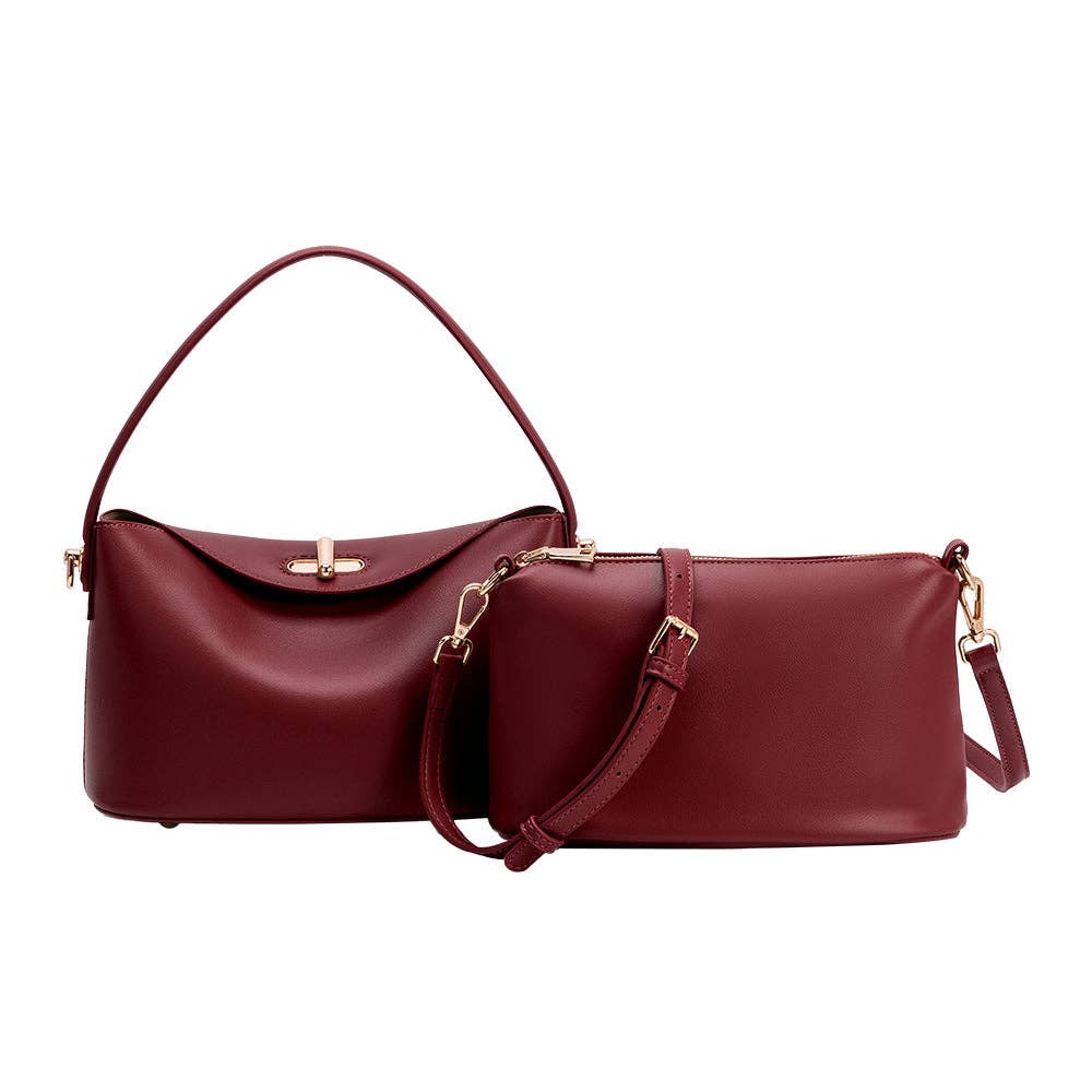 A matching two-piece handbag set in deep burgundy leather, featuring a larger top-handle bag and a smaller shoulder bag with gold-tone hardware, displayed against a solid white background.