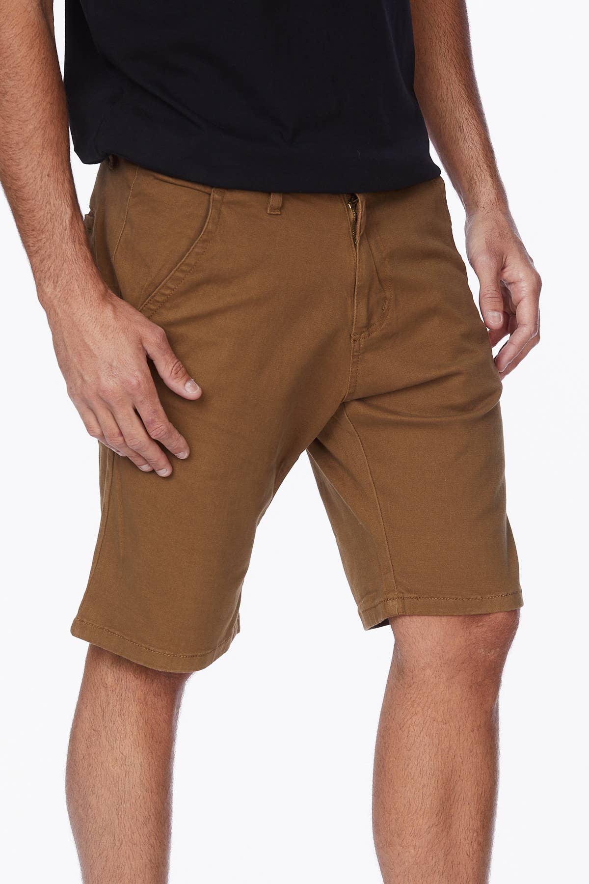 Male model wearing tobacco colored shorts with a black tee.