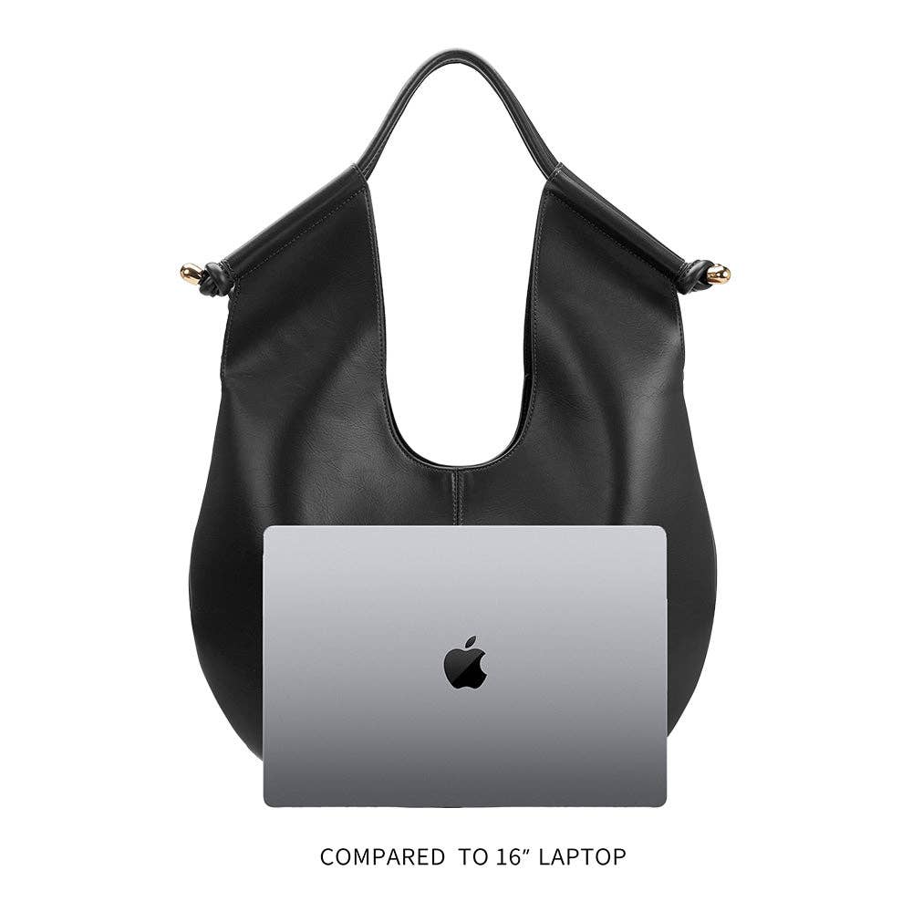 Black leather shoulder bag with knotted design and gold hardware on the handles with ipad for scale.