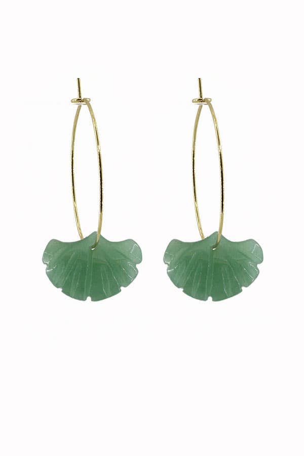 Green leaf-shaped earrings on gold hoop wires against a white background