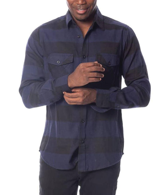 male model wearing a blue & black flannel shirt and black jeans