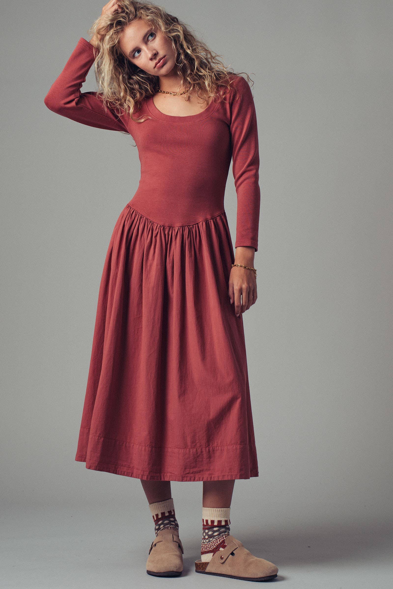 Woman wearing a red dress against a gray background