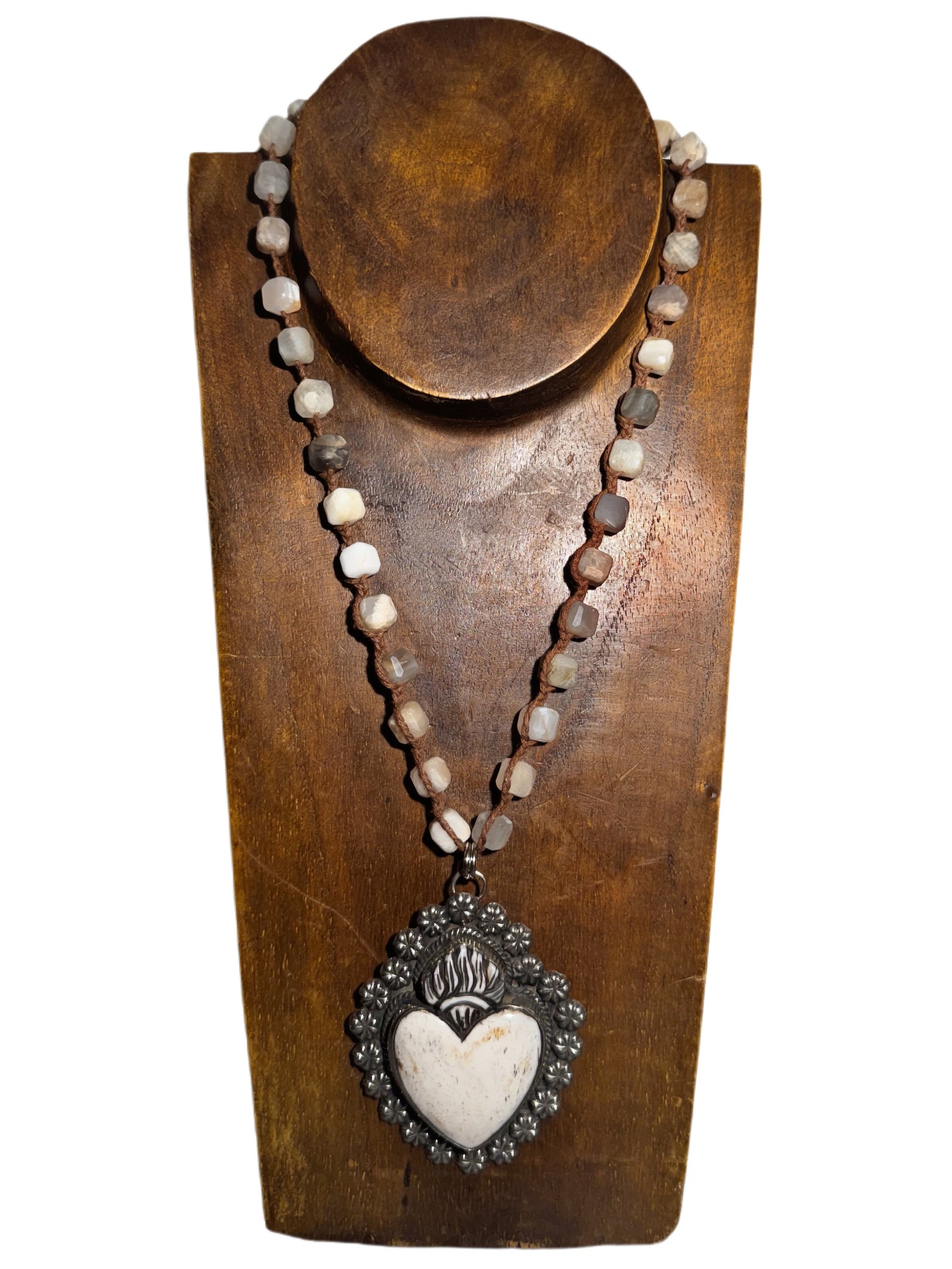 Necklace with heart pendant on a wooden stand